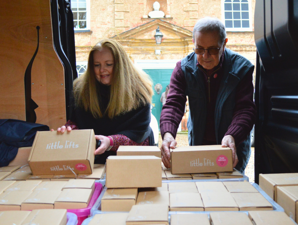 Breast Cancer Charity Volunteers Loading Gift Boxes into Van