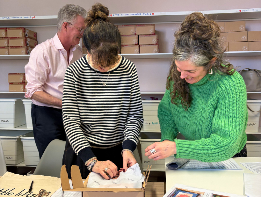 Breast cancer charity team and trustees packing gift Boxes