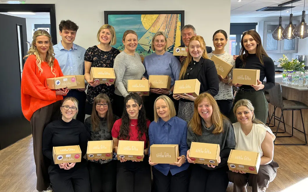 New corporate partners holding breast cancer charity gift Boxes