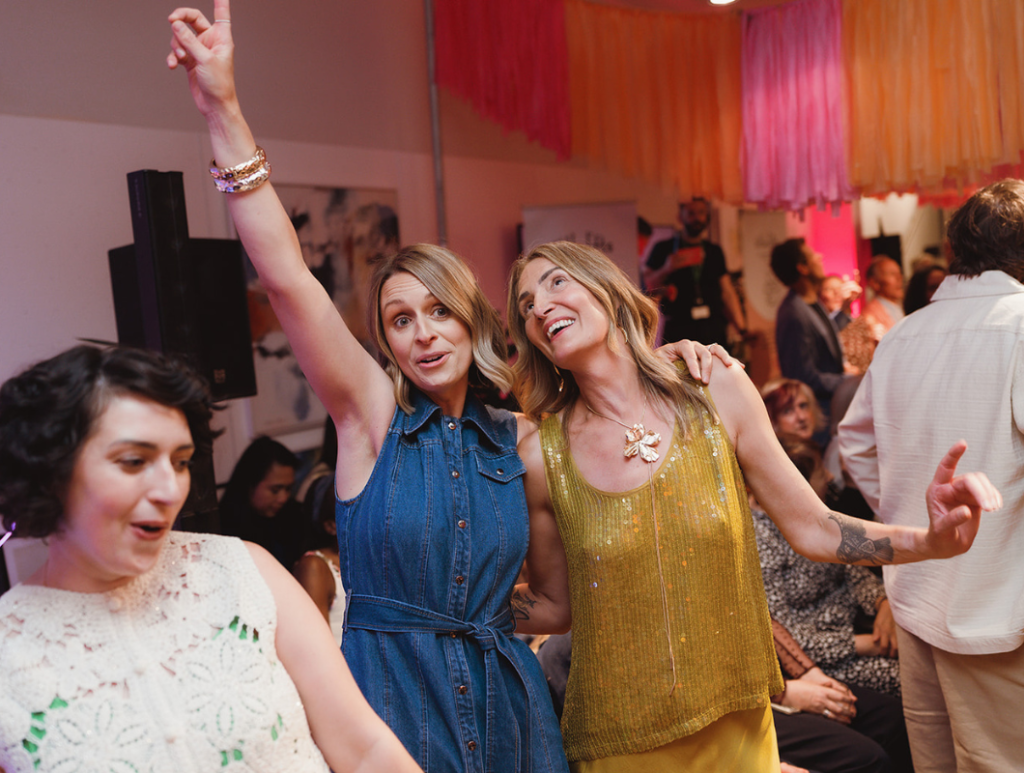 Founder with beneficiaries dancing