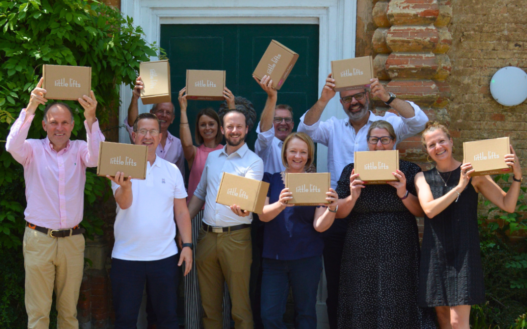 Little Lifts breast cancer charity team with supporters New Homes Group