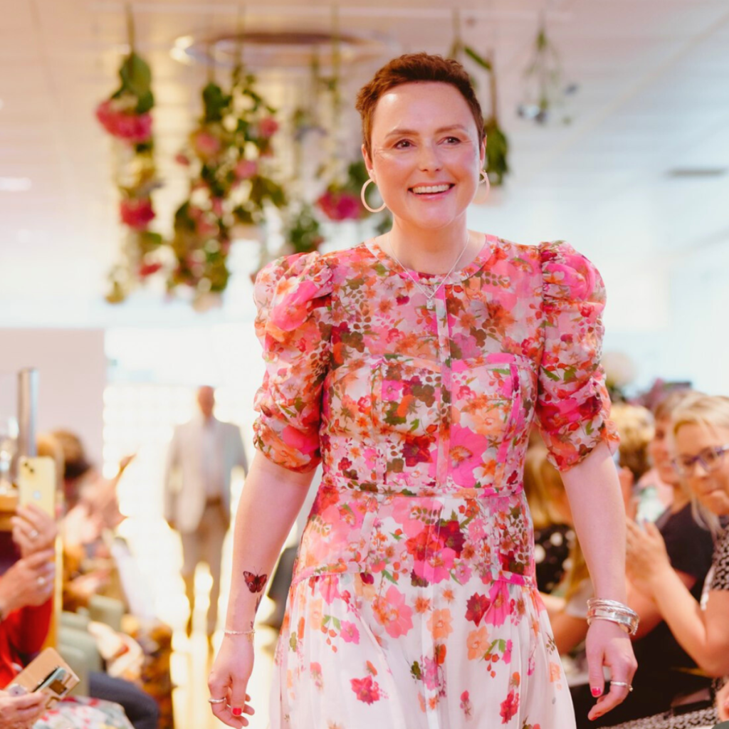 Breast cancer charity gift box beneficiary modelling in fashion show