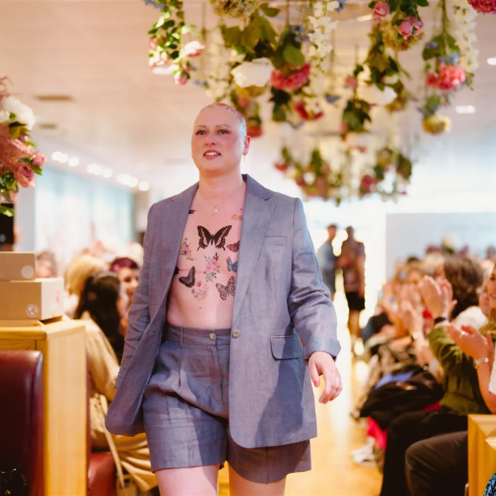 Breast cancer charity gift box beneficiary modelling in fashion show