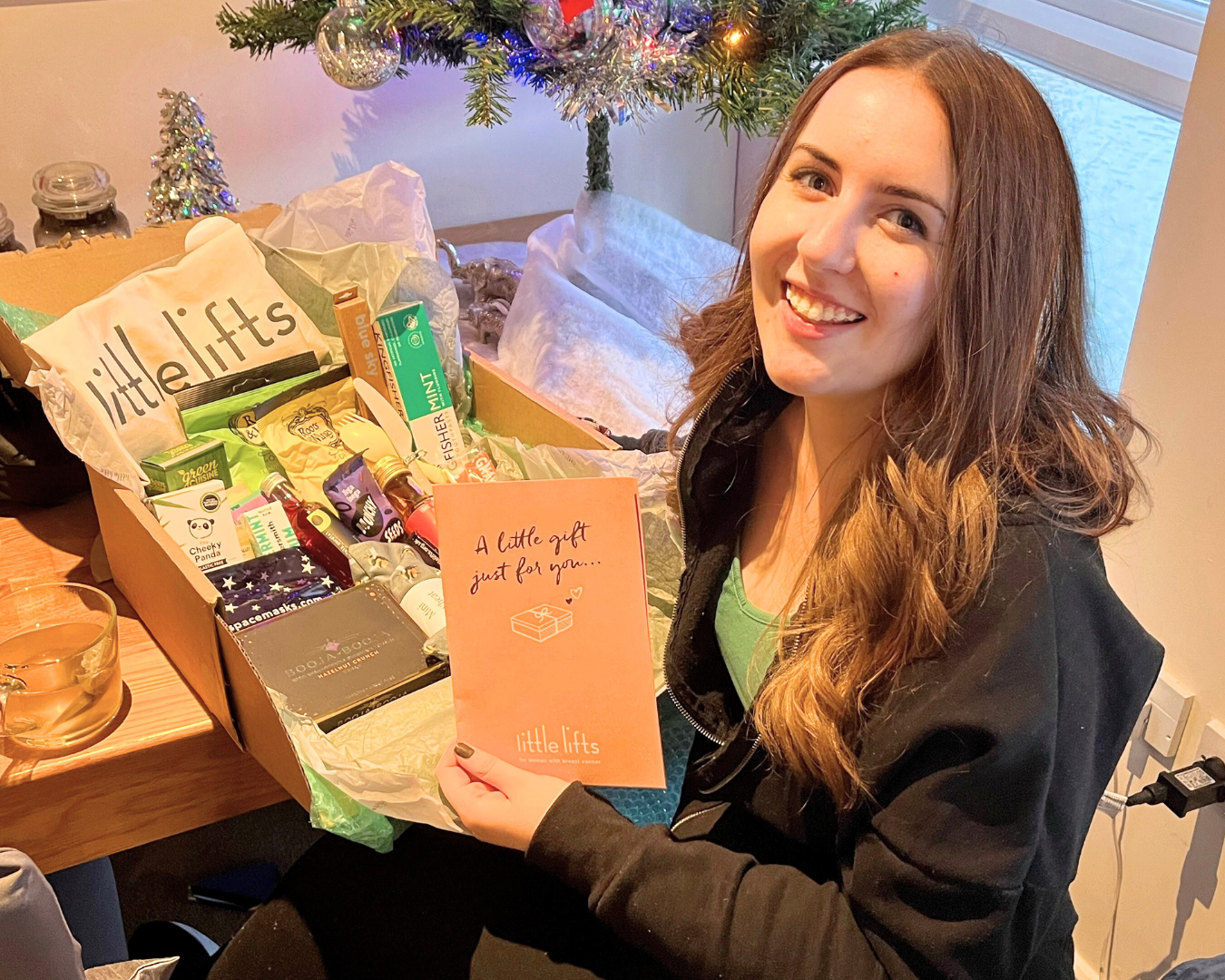 Breast cancer charity beneficiary with gift box