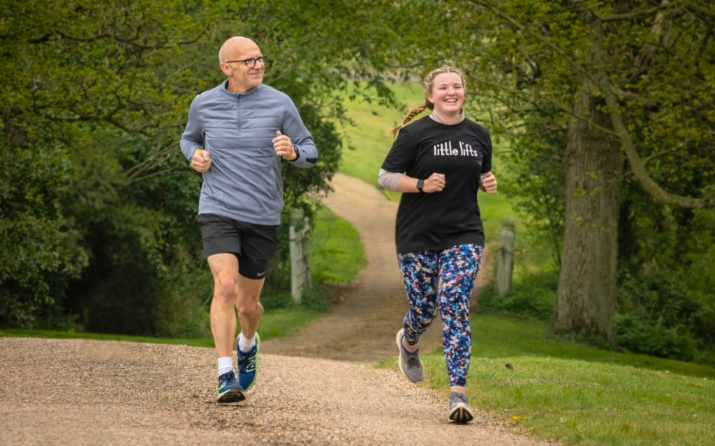 Two people from Little Lifts breast cancer charity community running