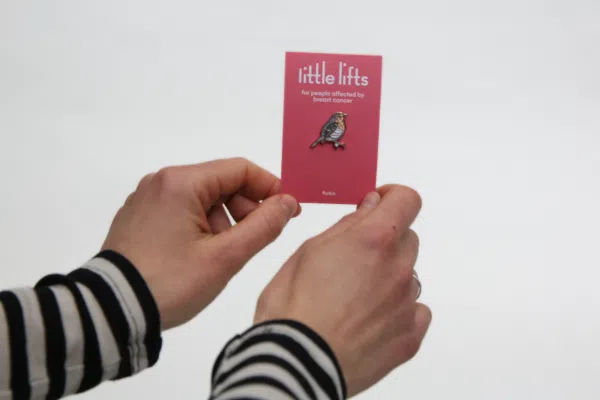 breast cancer charity pin and backing card