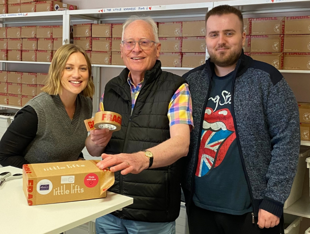 George Diggle with volunteers, taping a Little Lifts gift Box at charity HQ