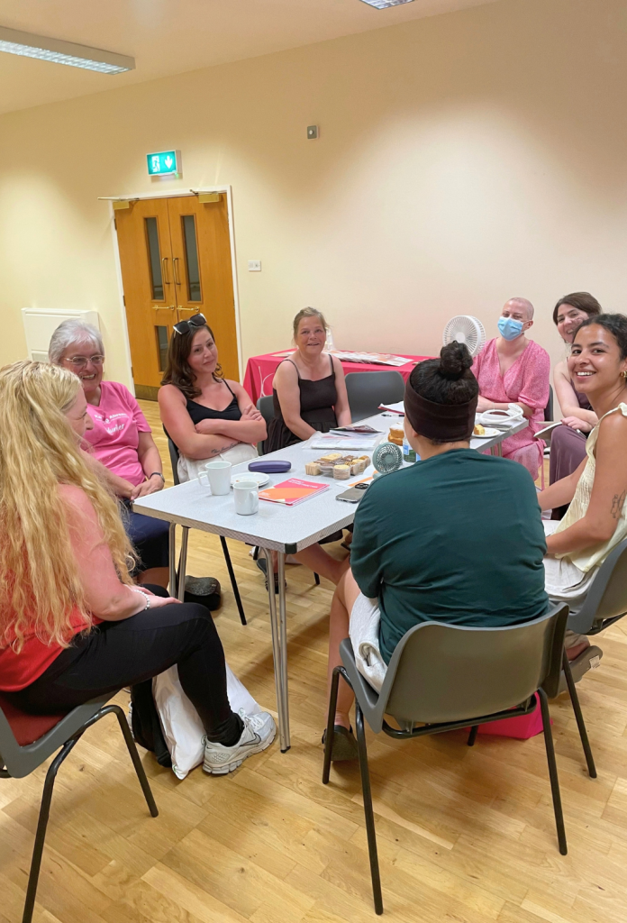 group of people sitting at the table for a keeping abreast breast cancer reconstruction surgery support meeting