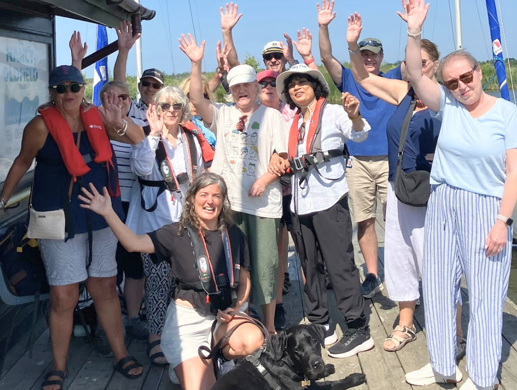 Little Lifts breast cancer community group waving and smiling on a boat trip with the Nancy Oldfield Trust