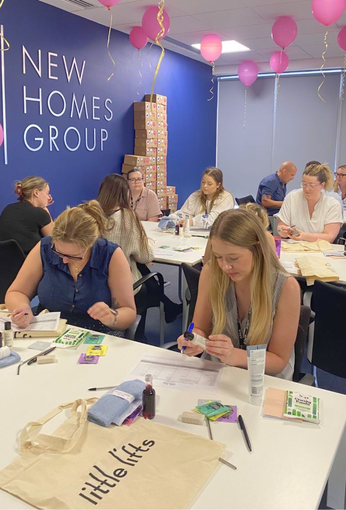 New Homes Group staff packing tote bags and care boxes for people with breast cancer.